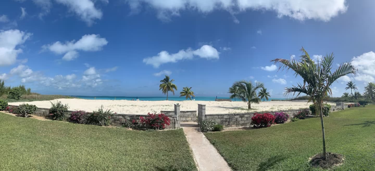 Lawn path opening onto Treasure Cay Beach